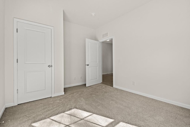 unfurnished bedroom with light carpet