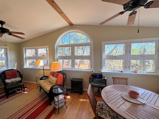 interior space with lofted ceiling with beams, ceiling fan, and plenty of natural light