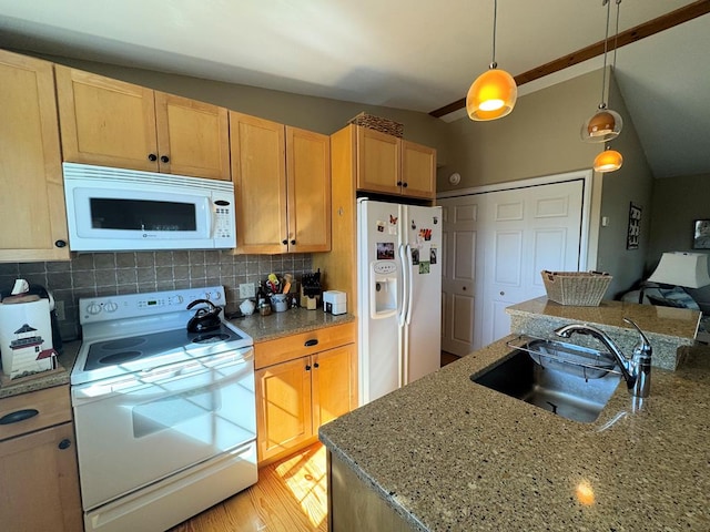 kitchen featuring decorative light fixtures, backsplash, vaulted ceiling, a sink, and white appliances