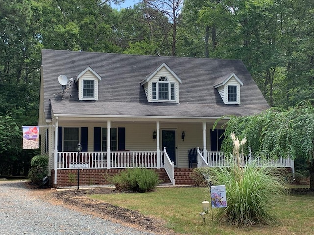 new england style home featuring a front yard