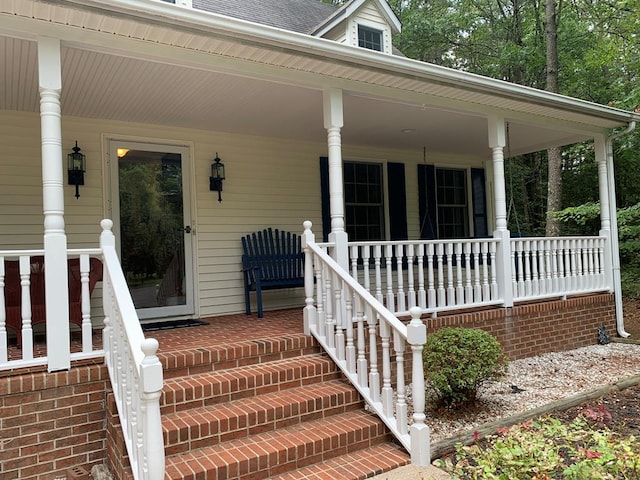 view of exterior entry with a porch