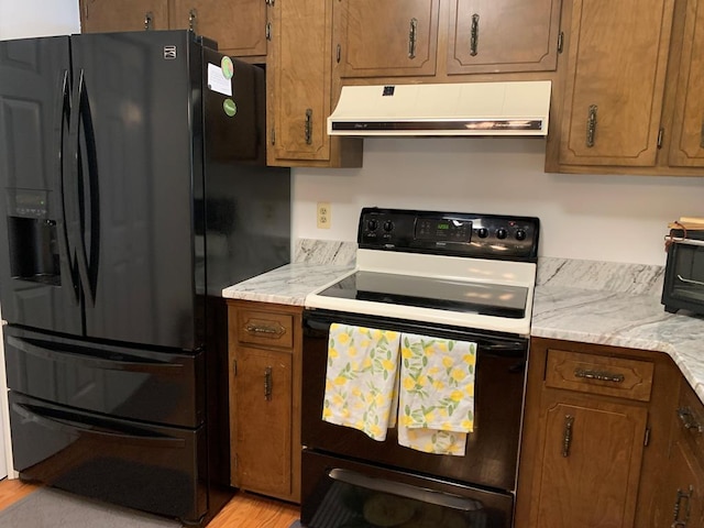 kitchen featuring black fridge with ice dispenser, light hardwood / wood-style floors, and white electric stove