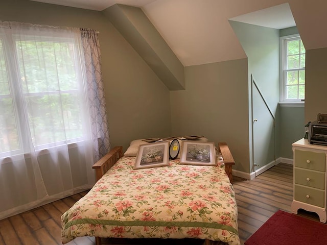 bedroom featuring wood-type flooring and vaulted ceiling