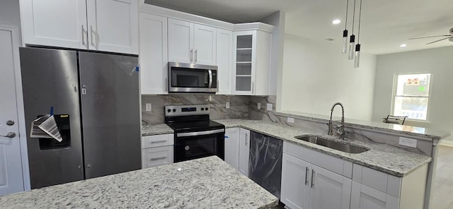 kitchen featuring white cabinetry, sink, hanging light fixtures, tasteful backsplash, and appliances with stainless steel finishes