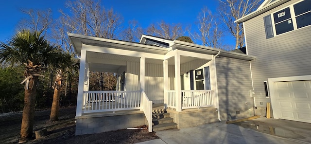 property entrance featuring a porch and a garage