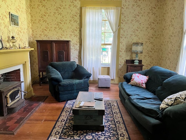 living room with dark hardwood / wood-style floors and a wood stove