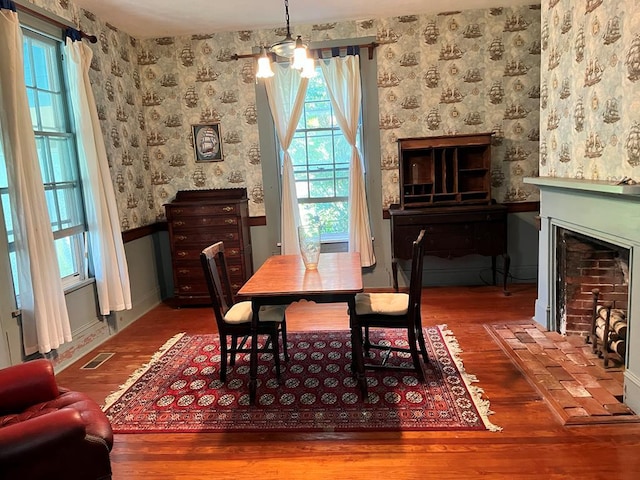 dining space featuring a notable chandelier and hardwood / wood-style flooring