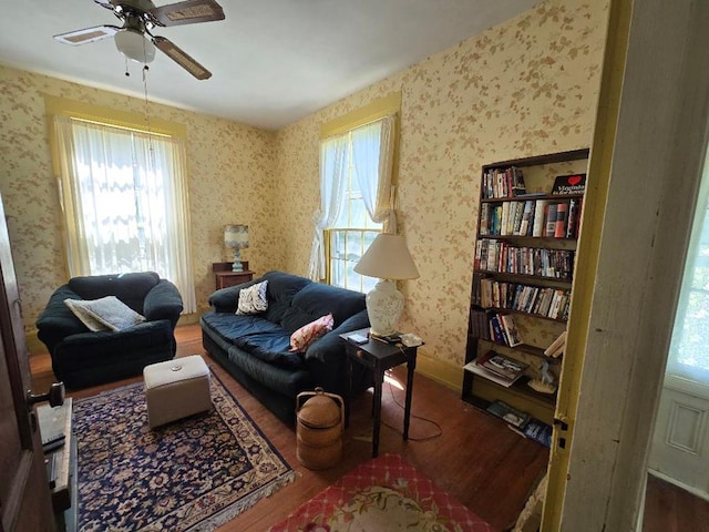 living area featuring hardwood / wood-style floors and ceiling fan