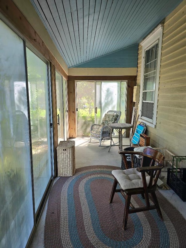 sunroom featuring vaulted ceiling