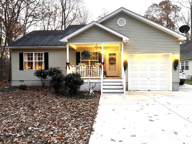 ranch-style home featuring covered porch and a garage