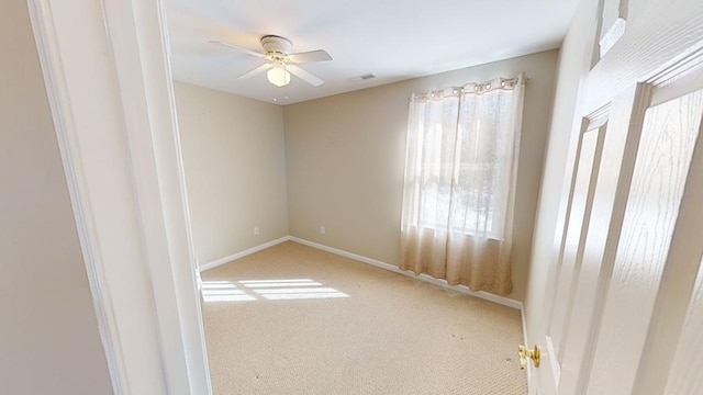 spare room featuring carpet flooring and ceiling fan