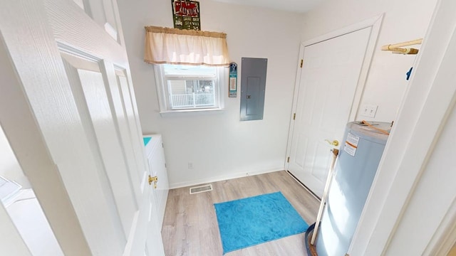 interior space featuring electric panel and light hardwood / wood-style flooring