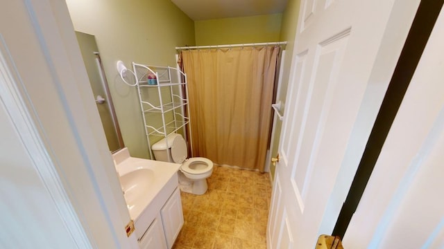 bathroom with vanity, toilet, and walk in shower