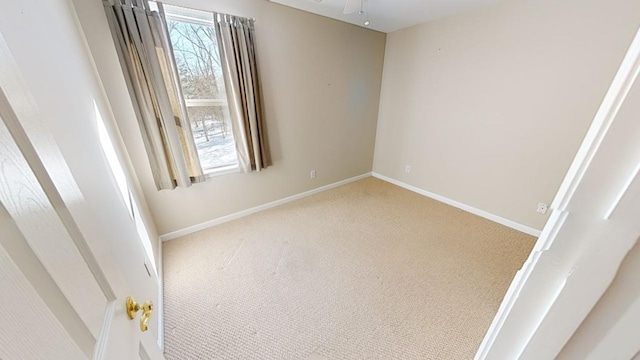 empty room featuring carpet floors and ceiling fan