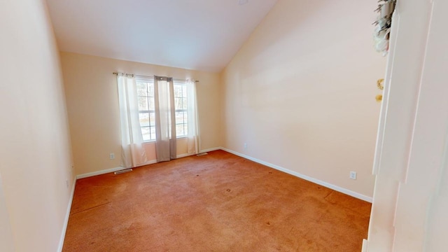 carpeted spare room with lofted ceiling