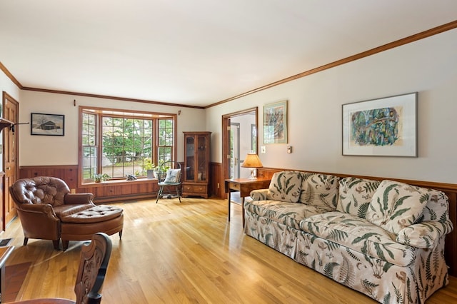 living room featuring wood walls, light hardwood / wood-style flooring, and ornamental molding