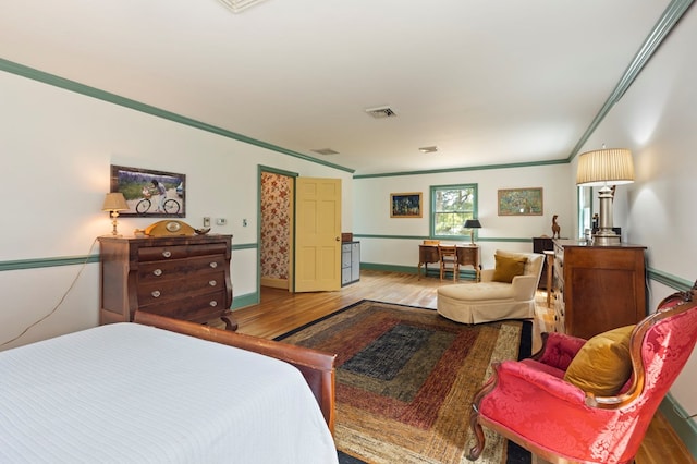 bedroom featuring hardwood / wood-style flooring and crown molding