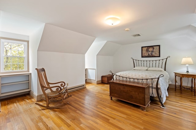 bedroom featuring light wood-type flooring and lofted ceiling