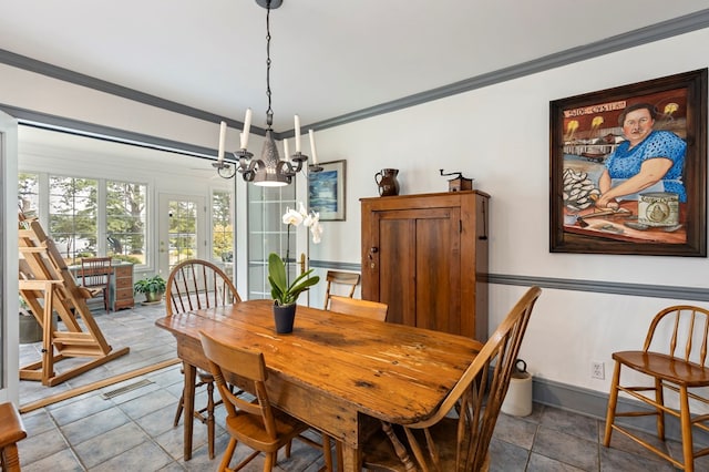 dining space with crown molding and an inviting chandelier