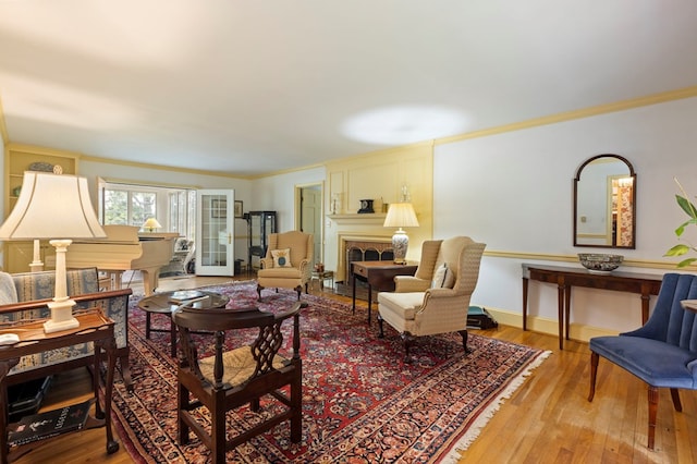 living room with crown molding and light hardwood / wood-style floors