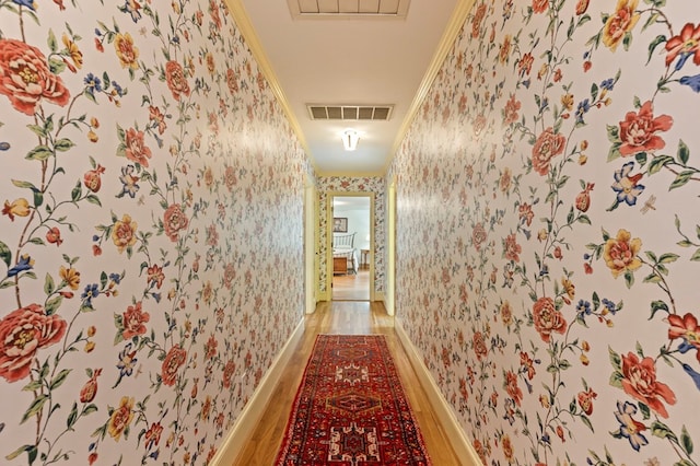 hall featuring hardwood / wood-style floors and ornamental molding