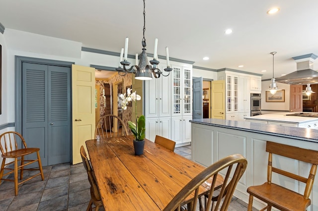 dining space featuring crown molding and an inviting chandelier