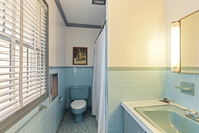 bathroom featuring vanity, tile patterned flooring, toilet, ornamental molding, and tile walls