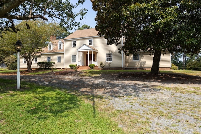 colonial inspired home with a front yard