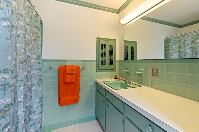 bathroom with vanity, tile patterned floors, crown molding, tile walls, and curtained shower