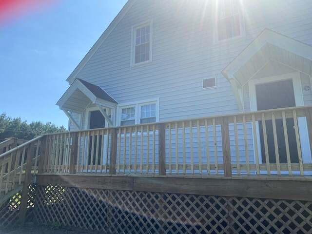 back house at dusk featuring a deck