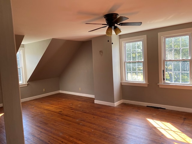 additional living space featuring lofted ceiling, ceiling fan, and dark wood-type flooring