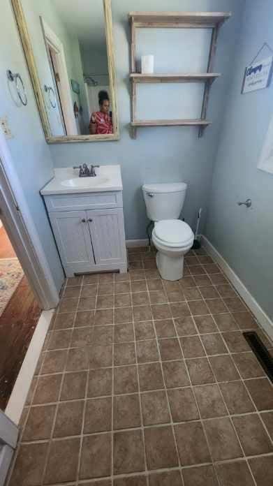 bathroom featuring vanity and toilet