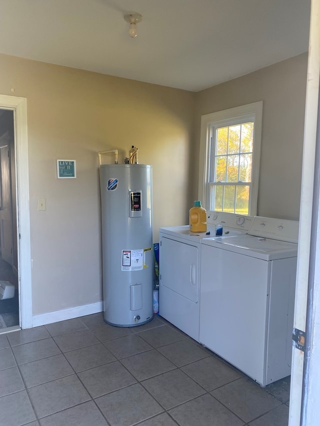 clothes washing area with tile patterned floors, washer and dryer, and electric water heater