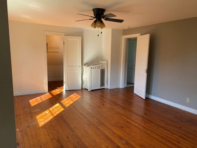 spare room with dark hardwood / wood-style floors and ceiling fan