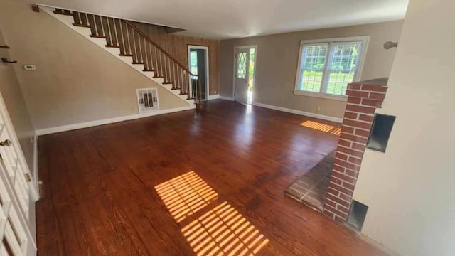 unfurnished living room featuring dark wood-type flooring