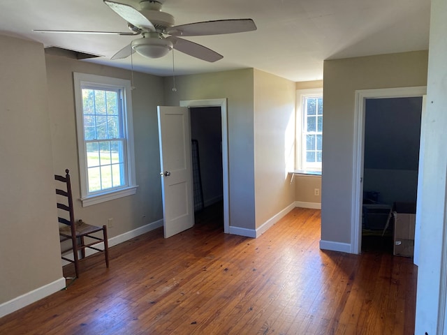 unfurnished bedroom featuring ceiling fan and dark wood-type flooring