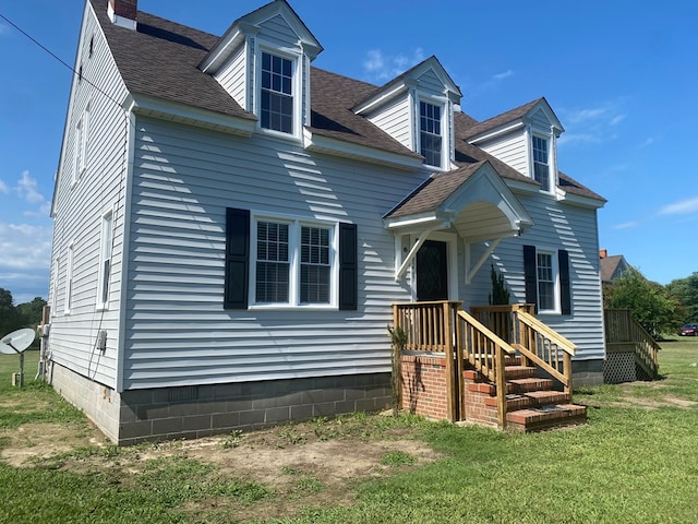 new england style home with a front yard