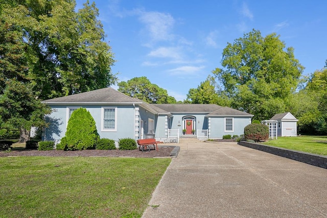 single story home with a storage shed and a front lawn