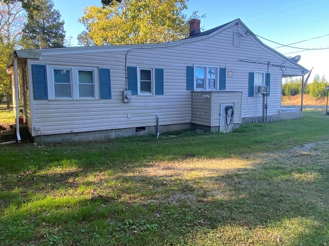 rear view of house featuring a yard and cooling unit