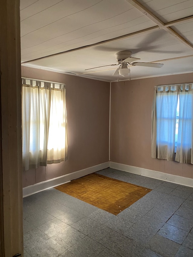 spare room with a wealth of natural light and ceiling fan