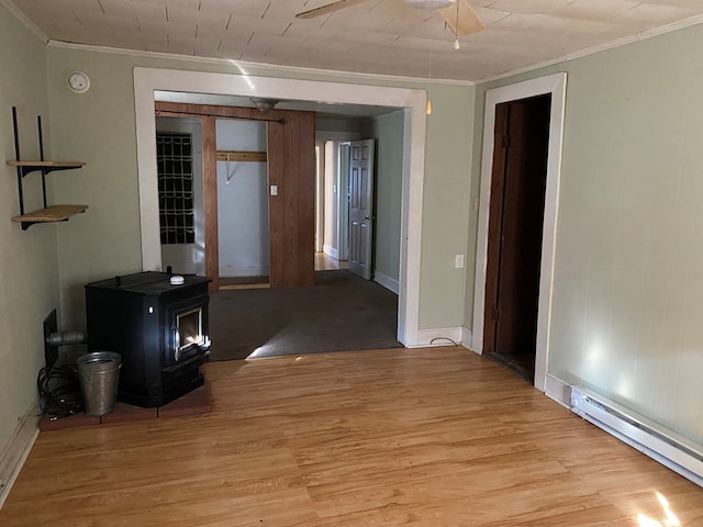 corridor featuring light wood-type flooring, a baseboard radiator, and crown molding