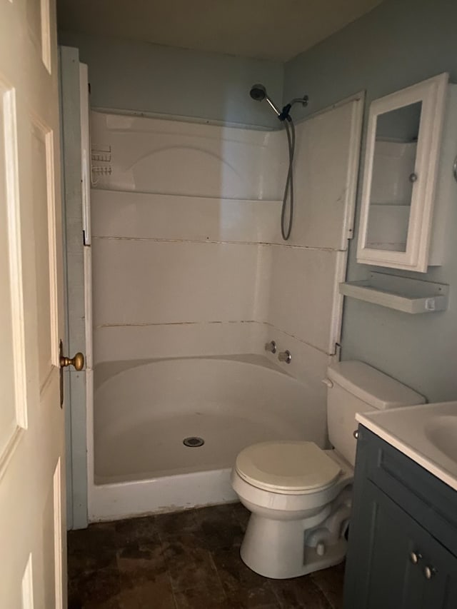 bathroom featuring vanity, toilet, and a shower