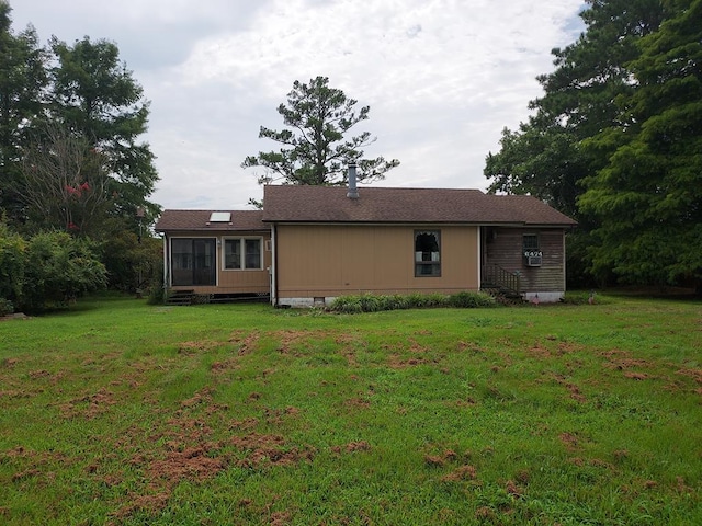 rear view of house with a lawn