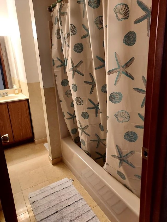 bathroom featuring tile patterned flooring, vanity, and shower / bath combo