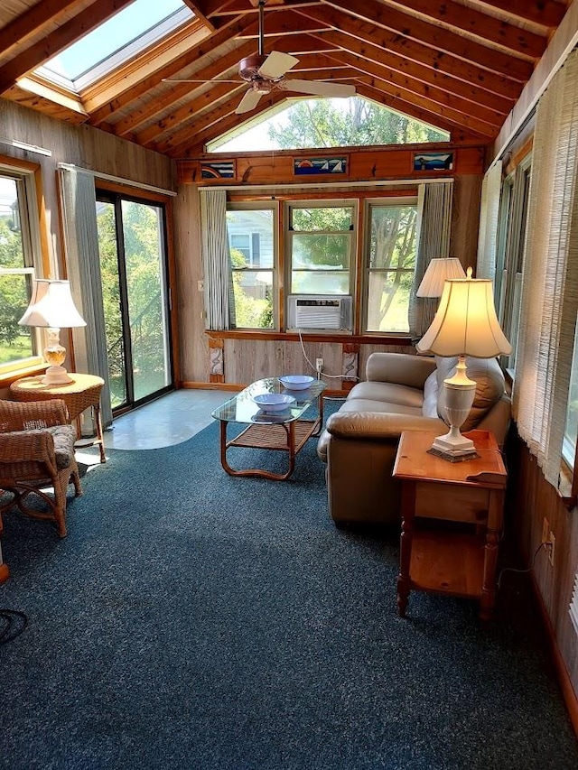 sunroom / solarium featuring lofted ceiling with skylight, cooling unit, and ceiling fan