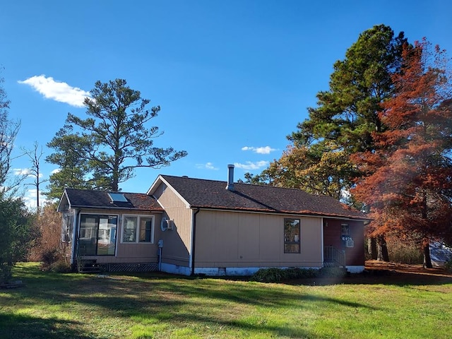 view of side of property with a yard