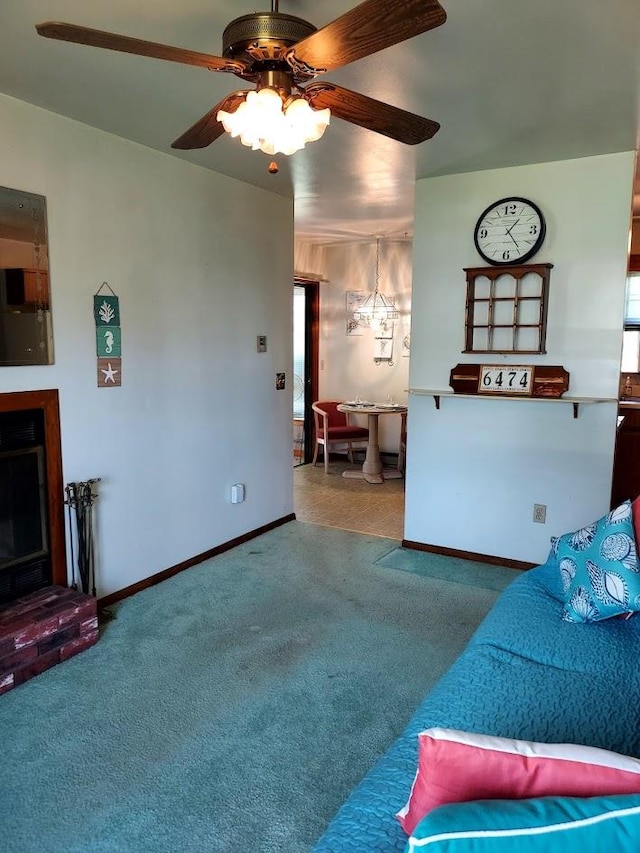 carpeted living room with a brick fireplace and ceiling fan