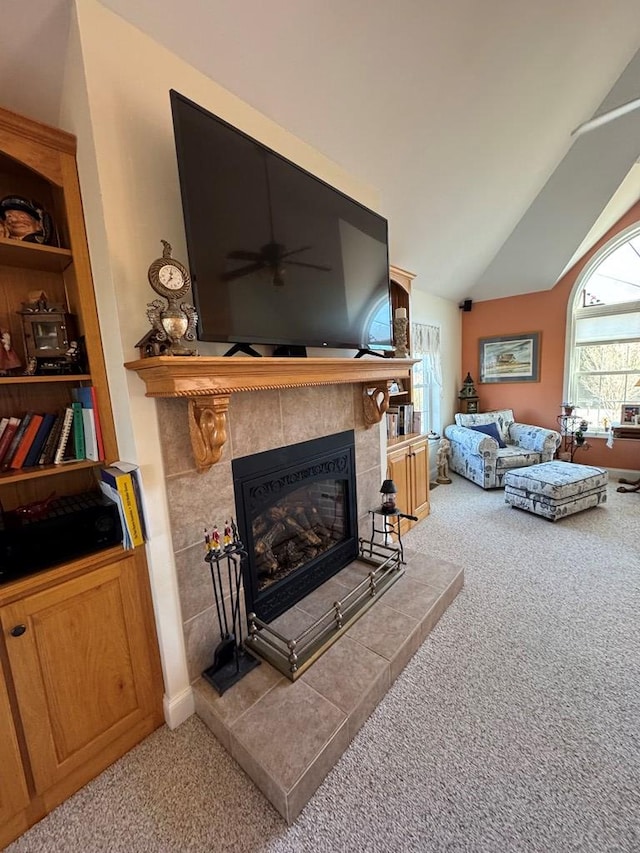 20444 Baldpate Ln, Onancock, VA 23417 - living room featuring light colored carpet, ceiling fan, vaulted ceiling, and a tile fireplace