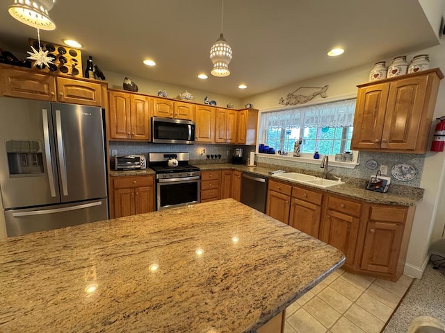 20444 Baldpate Ln, Onancock, VA 23417 - kitchen with appliances with stainless steel finishes, light stone countertops, tasteful backsplash, brown cabinetry, and recessed lighting