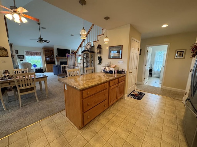 20444 Baldpate Ln, Onancock, VA 23417 - kitchen featuring a ceiling fan, light tile patterned floors, recessed lighting, brown cabinets, and pendant lighting